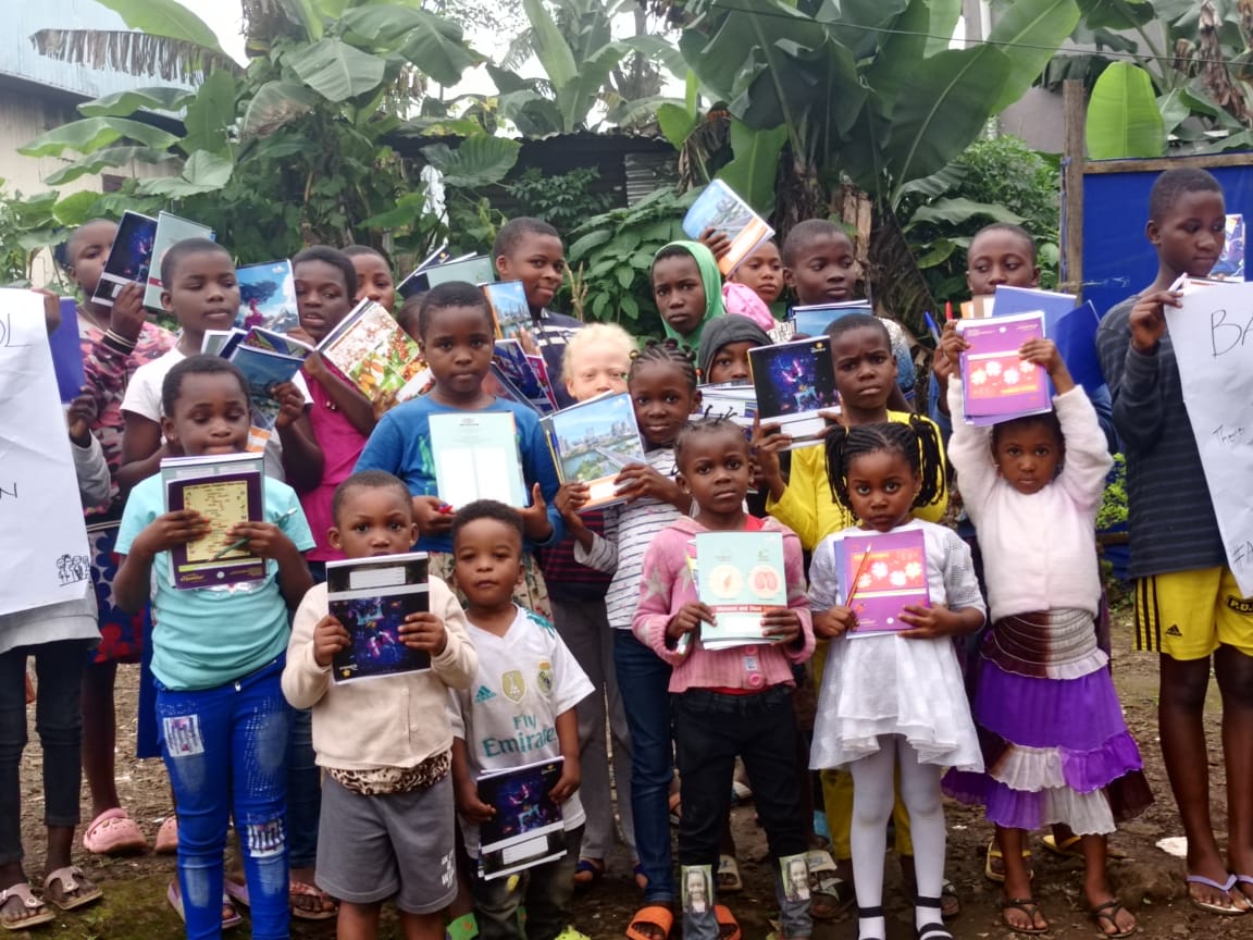 Children at the Children Safe Space receiving books and school materials